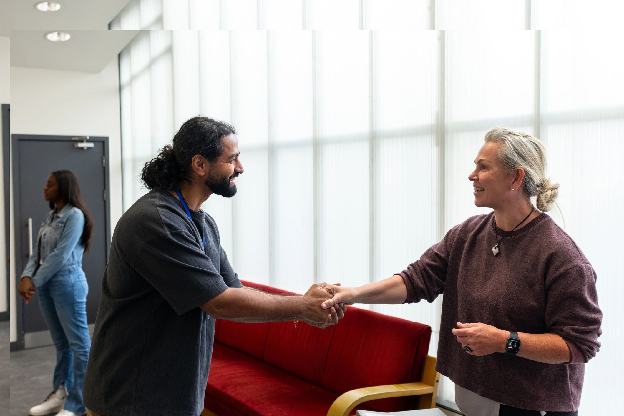 Business partners meeting and shaking hands at a trade event