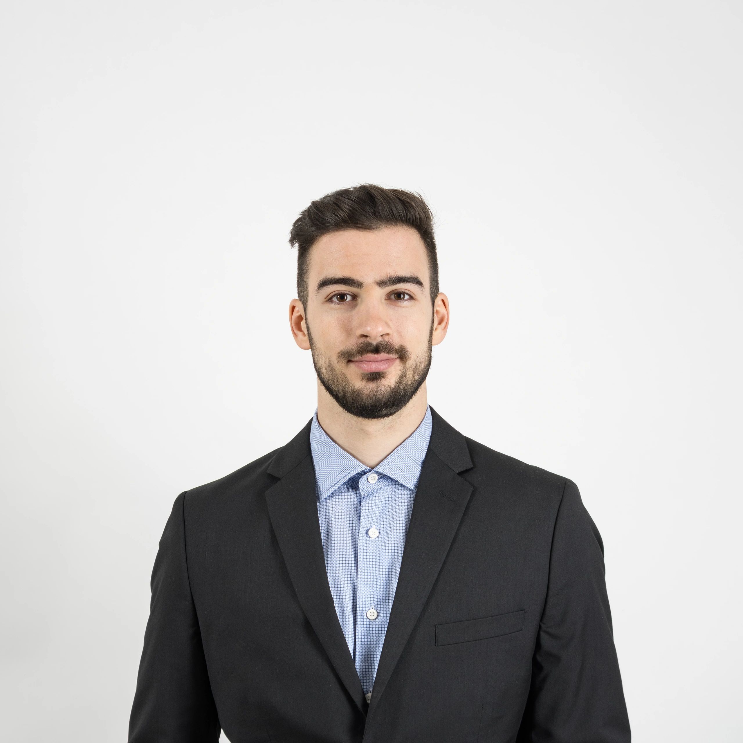 Professional headshot of a young man in a suit