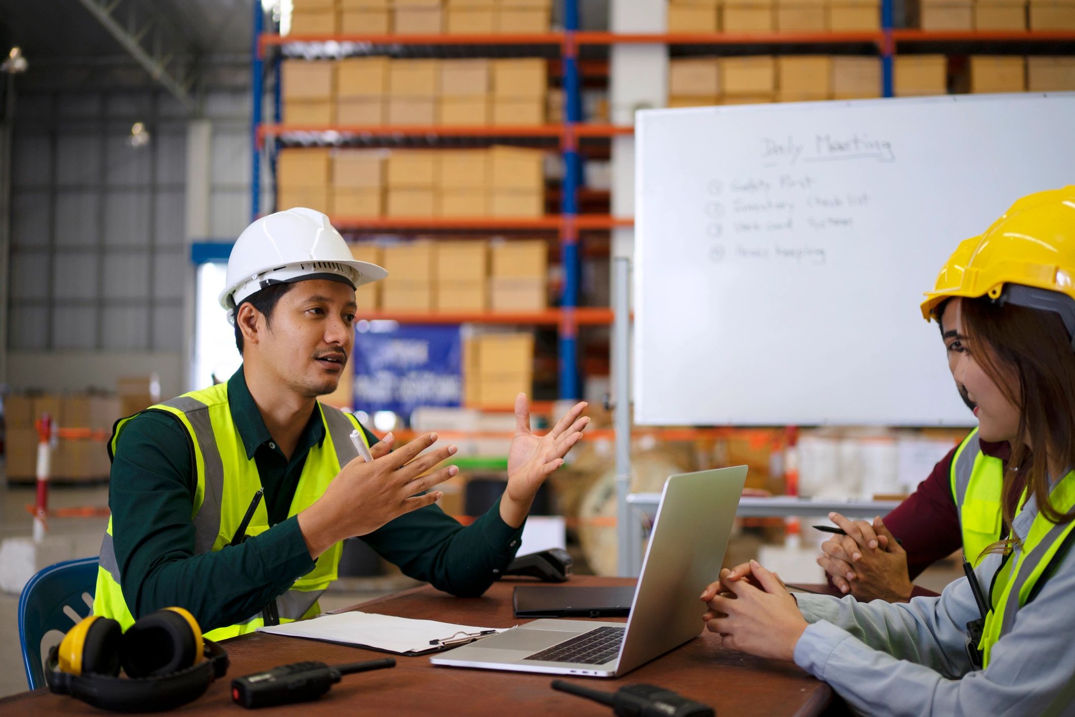 Blue collar workers are working at warehouse.