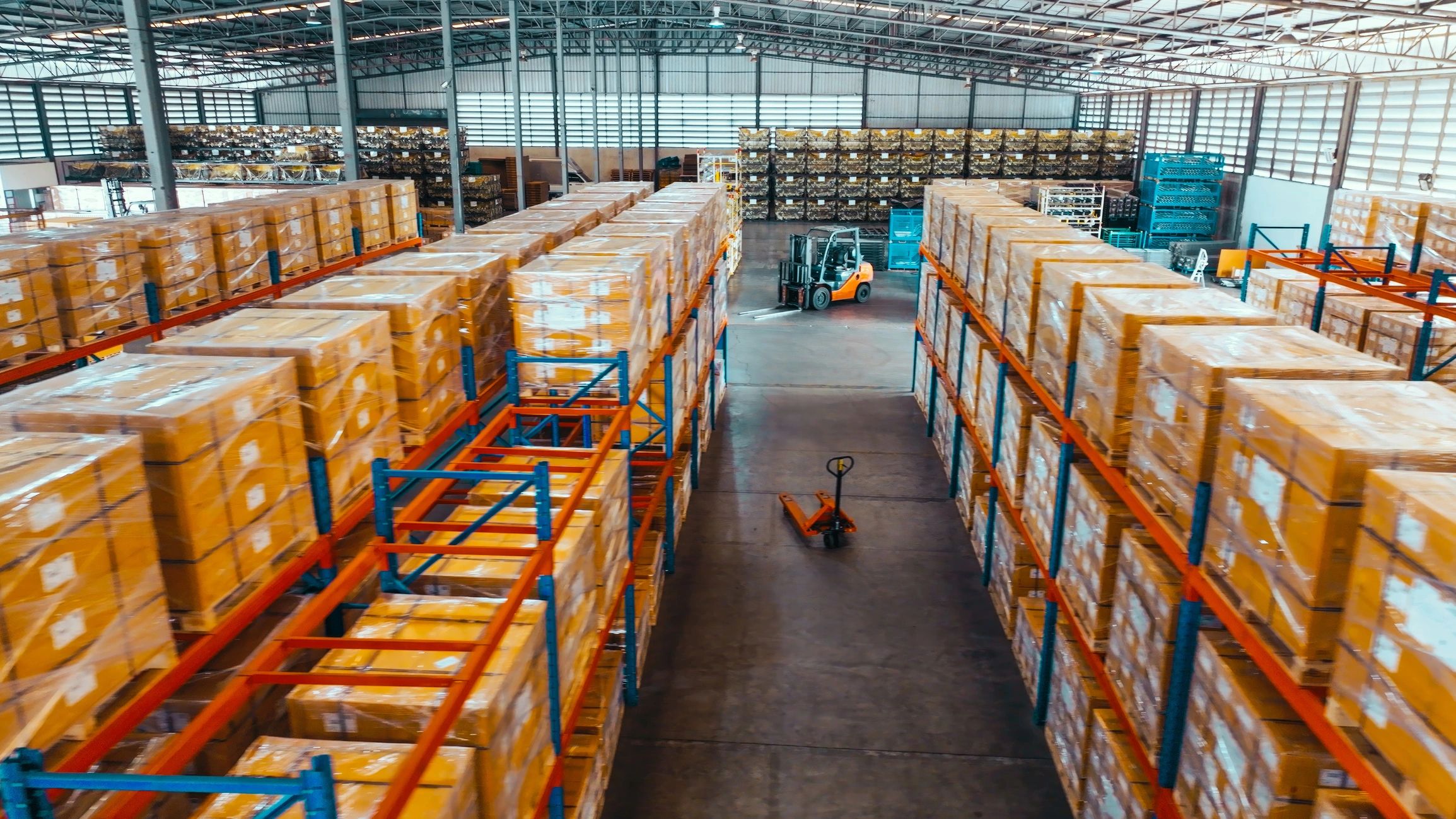Warehouse shelving and packaged goods representing sourcing and logistics support